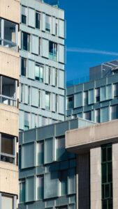 Contemporary urban architecture with modern buildings under a clear blue sky.